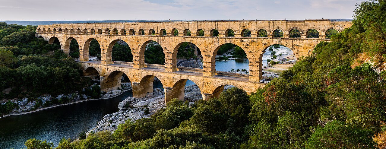 Podul roman Pont du Gard, cu trei rânduri de arcade suprapuse, traversând râul Gardon